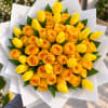 Bouquet of yellow roses and tulips wrapped in white paper
