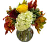 Yellow rose and white hydrangea arrangement in a glass vase