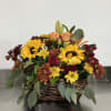 Gorgeous shades of fall. Sunflowers, lilies, spray roses, and assorted daisy poms.