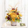 Autumn bouquet of yellow and burgundy flowers in a textured vase