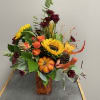 Brighten up someone's day with this beautiful and bright fall arrangement. This