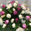 Pink and white roses with white spider mums in a large arrangement