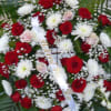 Red and white floral spray with roses and daisies