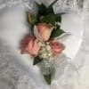 Designs are created with Roses or Spray Roses or Orchids.