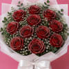 Bouquet of red roses with white filler flowers and a white ribbon wrap