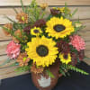 Sunflower and chrysanthemum arrangement in a brown ceramic vase