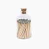 Glass bottle filled with wooden matches and sealed with a cork lid