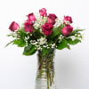 Pink roses and baby's breath in a clear glass vase