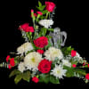 This upright, layered arrangement showcases lush red roses at the core, surrounded