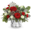 Red roses and white mums in a clear glass vase with pinecones