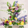 Colorful mixed flower arrangements with roses, delphinium, and orchids in glass vases