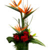 Tall tropical arrangement with red roses in a glass vase