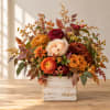 Autumn floral arrangement in a rustic white wooden box