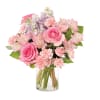 Pink rose, carnation, and alstroemeria bouquet with lavender stock in a clear glass vase