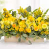 Yellow floral arrangement in a rectangular wooden box