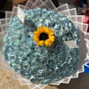 Round bouquet of blue roses with a yellow sunflower center