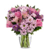 Pink and purple mixed bouquet in a clear glass vase