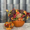 Pumpkin filled with mix flower arrangement of dahlias, roses, lilies, orchids, marigolds