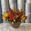 Beautiful gold vase filled with yellow and orange roses and some decorative
