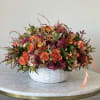 Autumn arrangement in the white ceramic vase 
