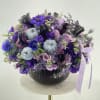 Beautiful dark brown pumpkin with the purple arrangement of fresh flowers!