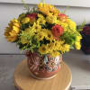 Yellow mixed bouquet with roses in a patterned ceramic vase