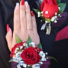 This luxury wrist corsage and coordinating boutonniere feature a premium, hand-selected red