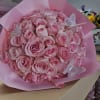 Bouquet of pink roses wrapped in pink paper with butterfly decorations