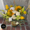 Vase arrangement of yellow sunflowers, white roses, and yellow tulips in a glass cylinder vase