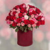 A tight dome of roses in vivid red, blush pink and a
