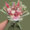 Blush pink and creamy white roses mingle with soft pink lisianthus and