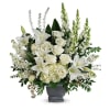 Tall white arrangement of lilies, roses, hydrangeas, and snapdragons in a gray pedestal vase