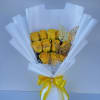 Bouquet of yellow roses wrapped in white paper with a yellow ribbon
