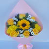 Bouquet of yellow roses, sunflowers, and white daisies wrapped in pink paper