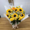 Bouquet of yellow sunflowers and roses wrapped in white paper