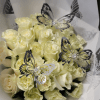 A cluster of pale yellow roses gathered into a rounded hand-tied bouquet