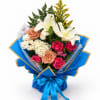 Bouquet of white lilies, roses, and mixed blooms wrapped in blue paper