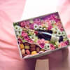 A lush cluster of pink roses framed around a chilled bottle of