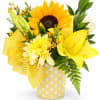 Yellow bouquet with a sunflower, lilies, and mums in a polka-dot container