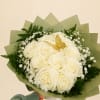 Bouquet of white roses with baby’s breath and green wrapping