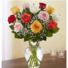 Mixed roses in a clear glass vase with baby's breath
