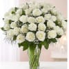 White rose bouquet in a clear glass vase