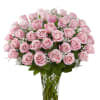 Pink roses arranged in a clear glass vase