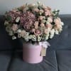 Pink and white bouquet in a round pink hat box