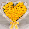 Heart-shaped bouquet of yellow roses wrapped in white paper with a gold ribbon