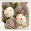 Box of chocolate-covered strawberries with heart decorations