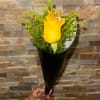Single yellow rose bouquet with greenery in black wrap