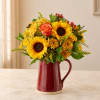 Sunflower and chrysanthemum bouquet in a red ceramic pitcher vase