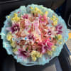 Pink rose bouquet with lilies, yellow filler flowers, and a ribbon bow