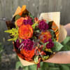 The blazing orange of the roses like fire, the deep magenta blooms